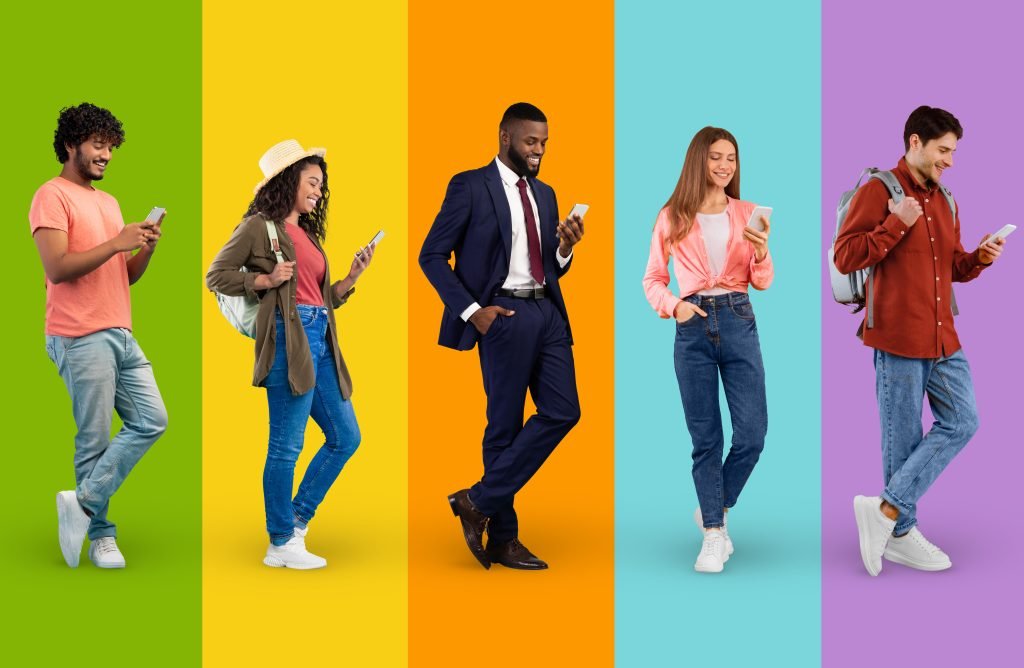 Diverse Multiethnic People Using Smartphones While Standing Over Colorful Backgrounds